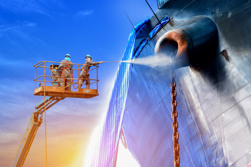 Workers spraying ship