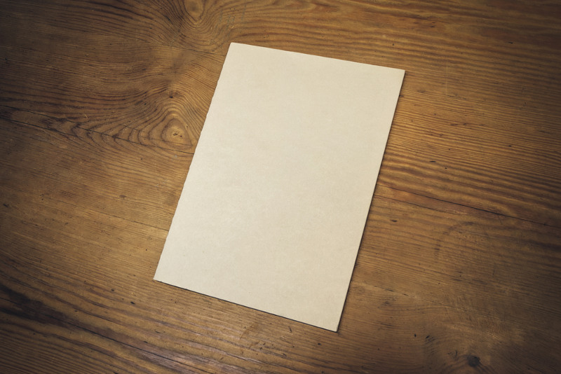 Empty paper sheet on dark wooden table